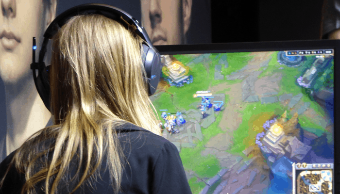 Woman playing computer game with headphone