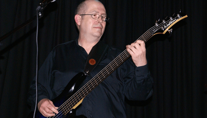 Man playing 5 string bass guitar